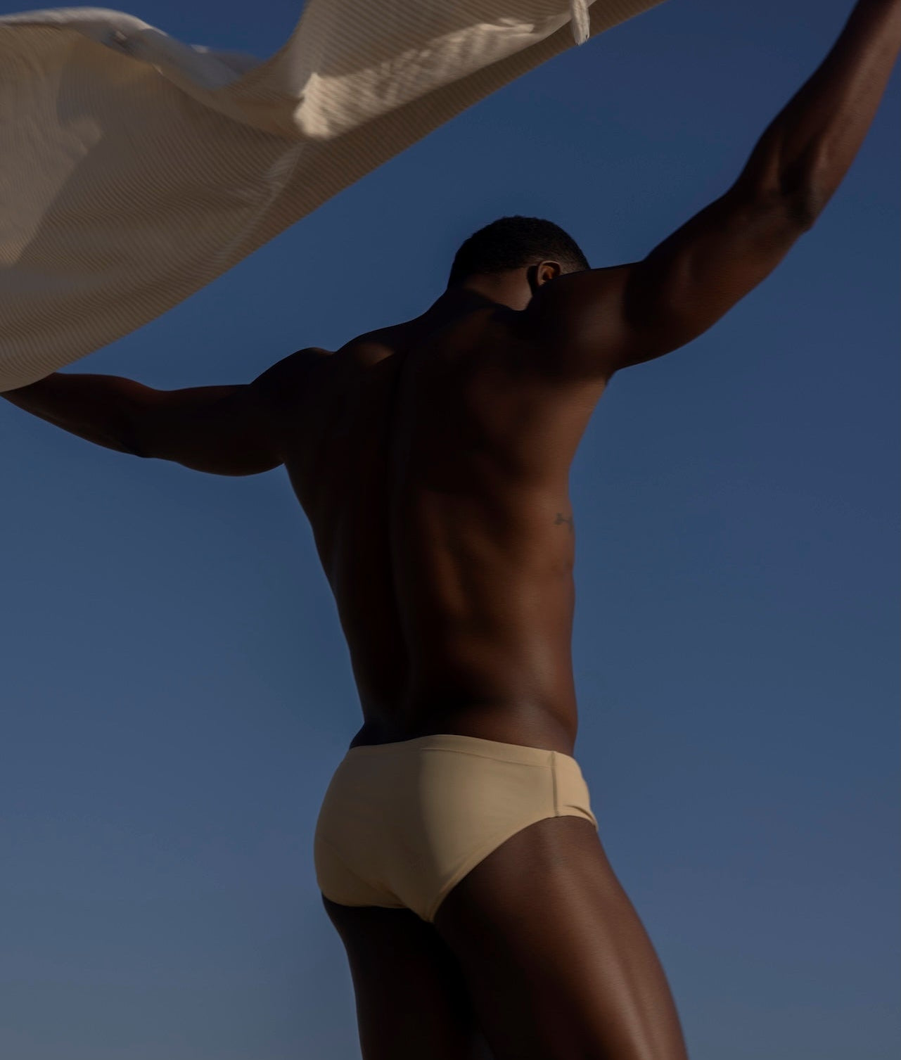 Sean & Val Classic Brief Ecru — men's swim brief back view showing minimal coverage
