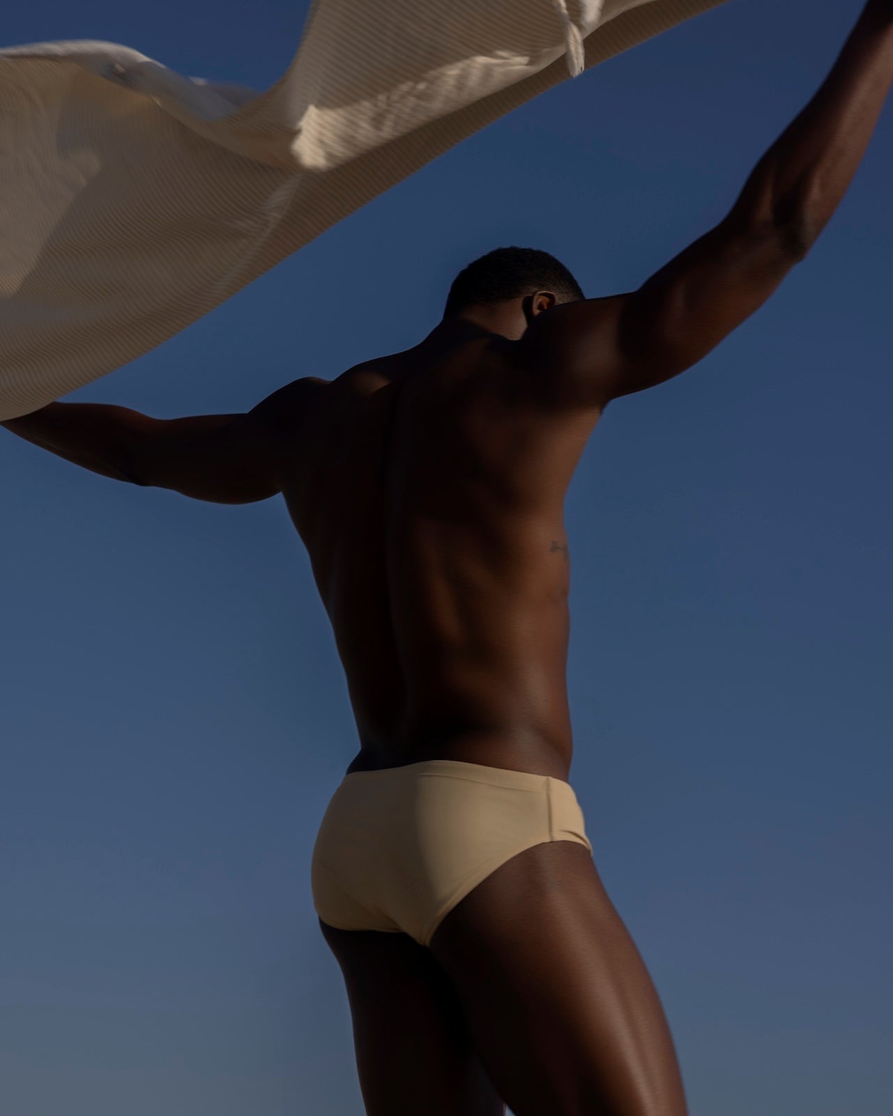Sean & Val Classic Brief Ecru — men's swim brief back view showing minimal coverage