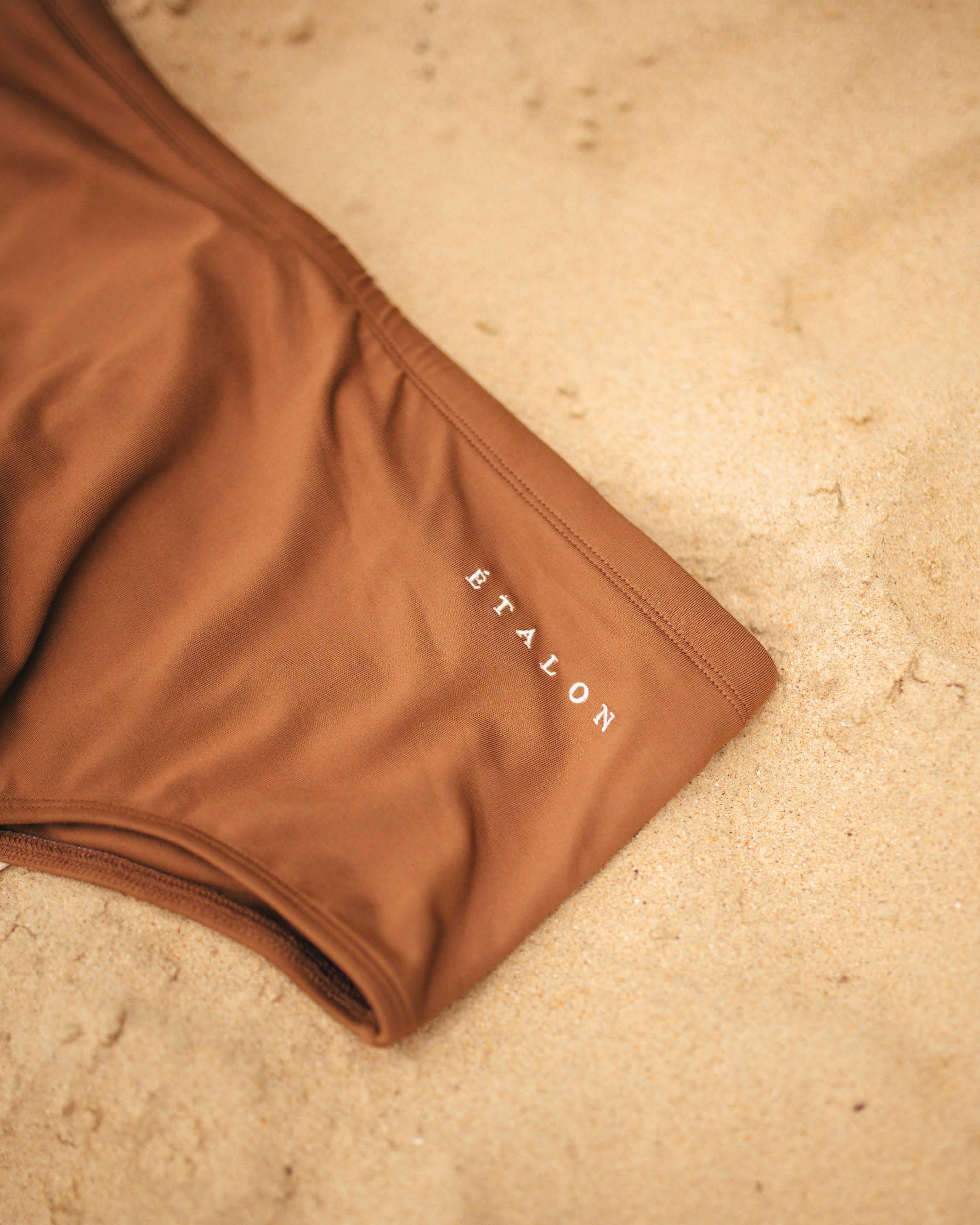 Étalon Brown Swim Sunga - men's swim brief action shot by water
