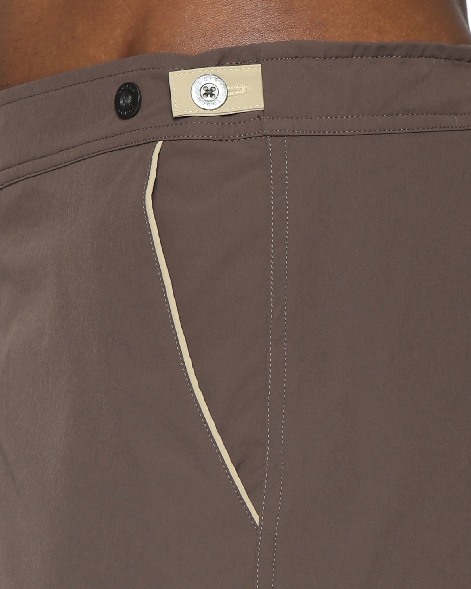 Parke & Ronen Catalonia Espresso Stretch Swim Short - close-up of accent waist tab detail