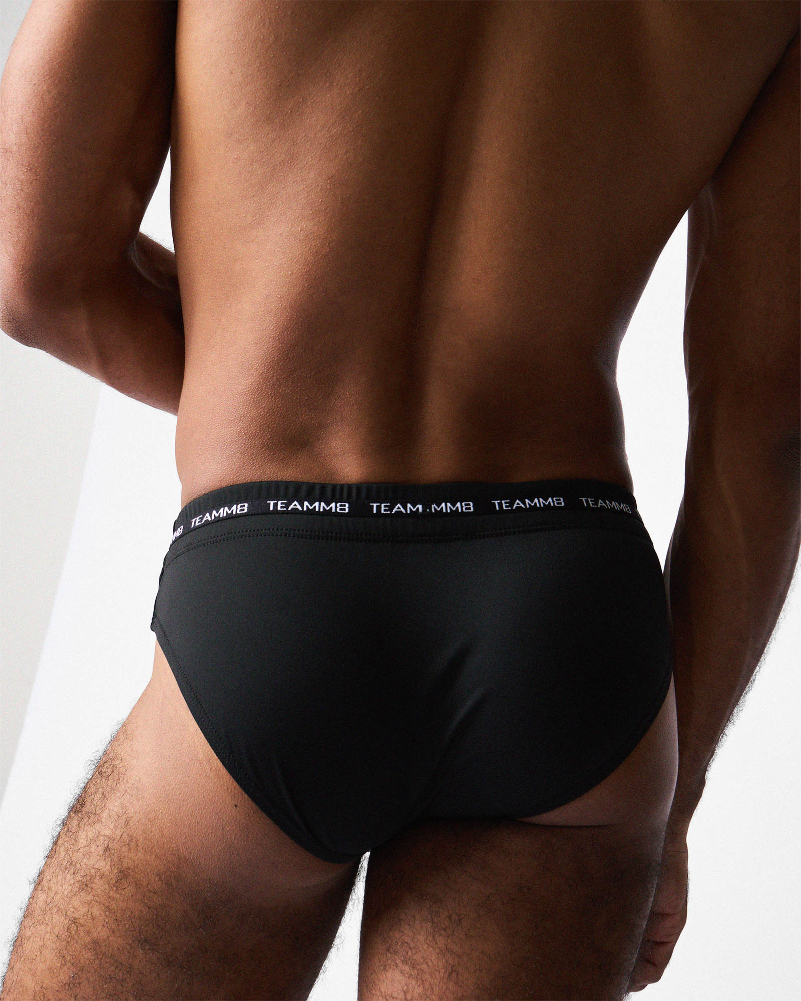 Teamm8 Ultra Swim Brief Jet - men's 4-way stretch swim brief poolside, back view
