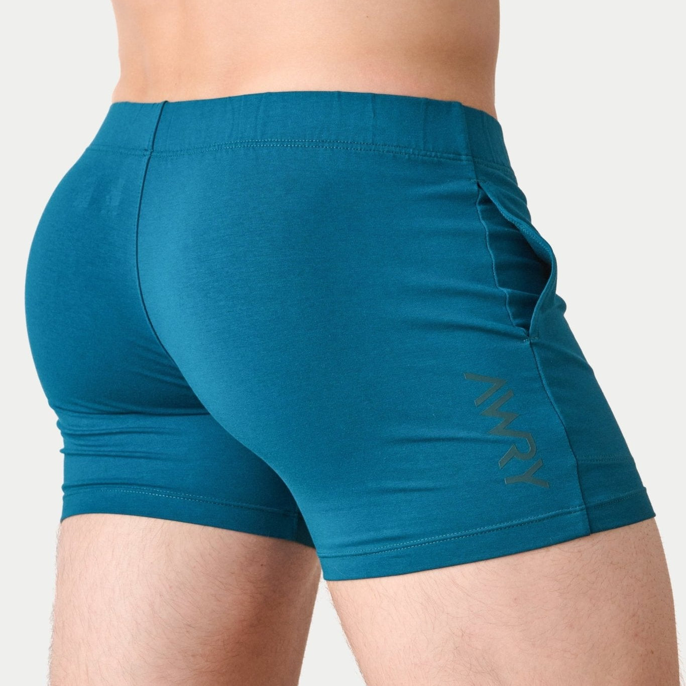 Awry Flow 4 Inch Short V2 Teal — side view showing roomy front pocket and smooth waistband