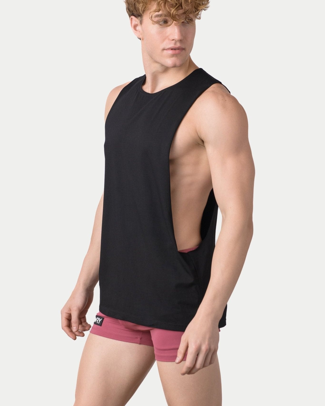 Awry Impact Tank Black — side view showing deep armhole cutout and relaxed draped silhouette