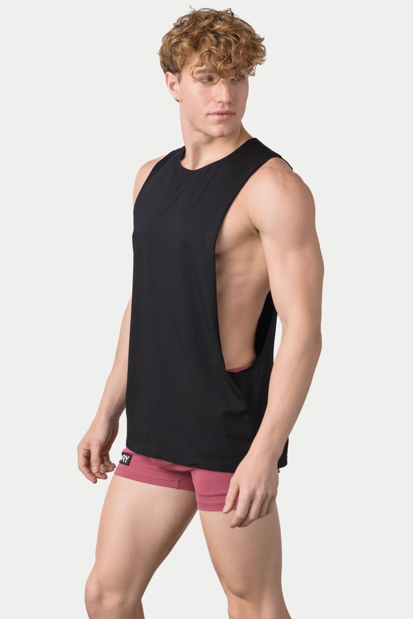 Awry Impact Tank Black — side view showing deep armhole cutout and relaxed draped silhouette