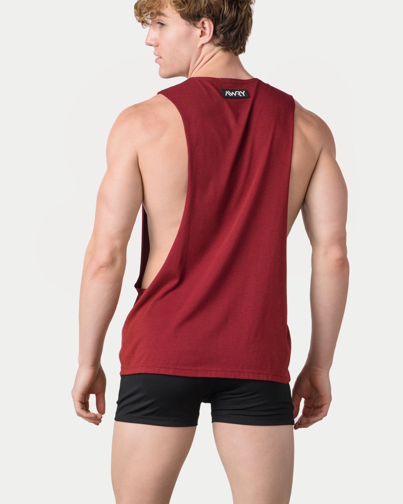 Awry Impact Tank Maroon — side view showing deep armhole cutout and relaxed draped silhouette