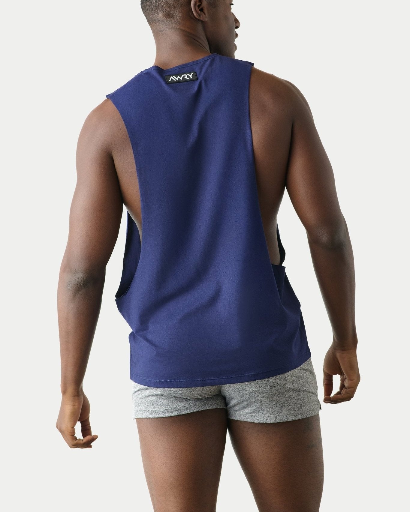 Awry Impact Tank Navy — side view showing deep armhole cutout and relaxed draped silhouette