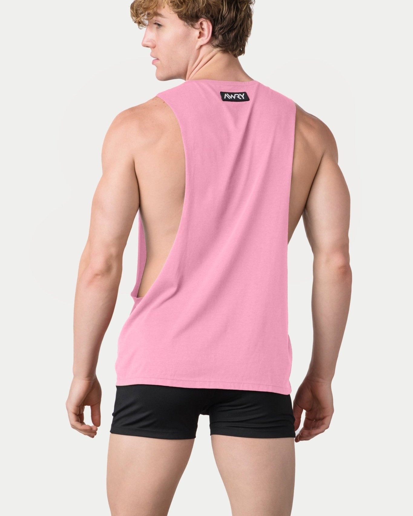 Awry Impact Tank Pink — side view showing deep armhole cutout and relaxed draped silhouette