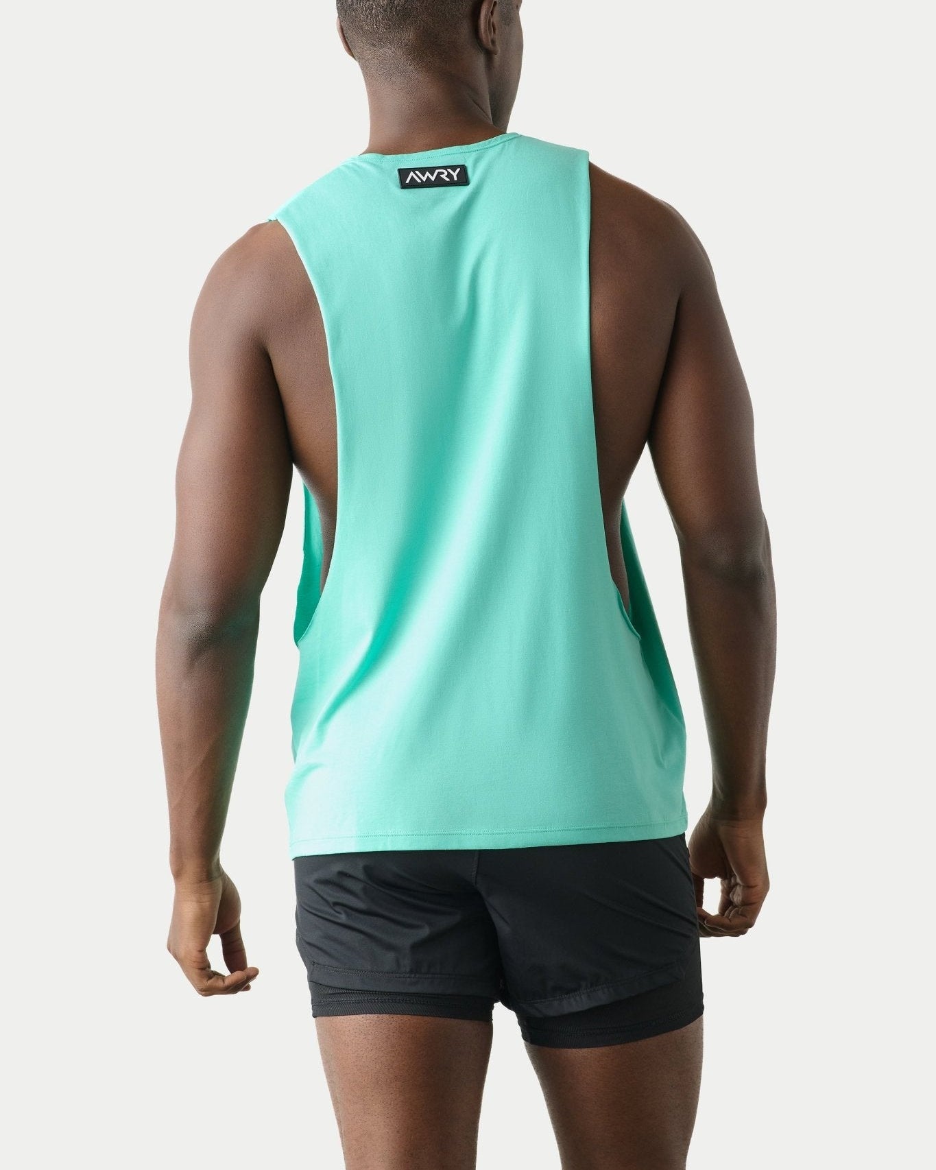 Awry Impact Tank Turquoise — side view showing deep armhole cutout and relaxed draped silhouette