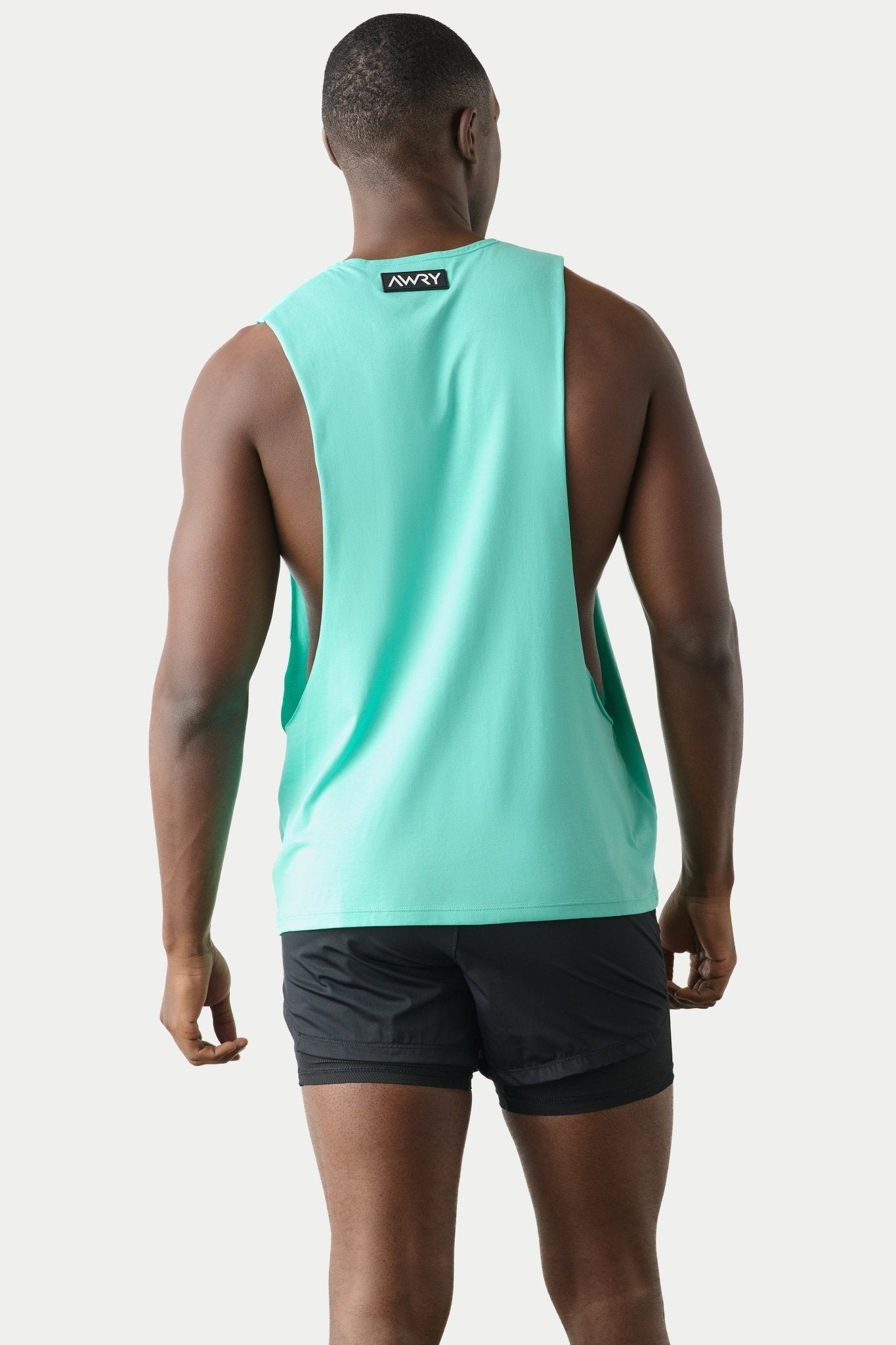 Awry Impact Tank Turquoise — side view showing deep armhole cutout and relaxed draped silhouette