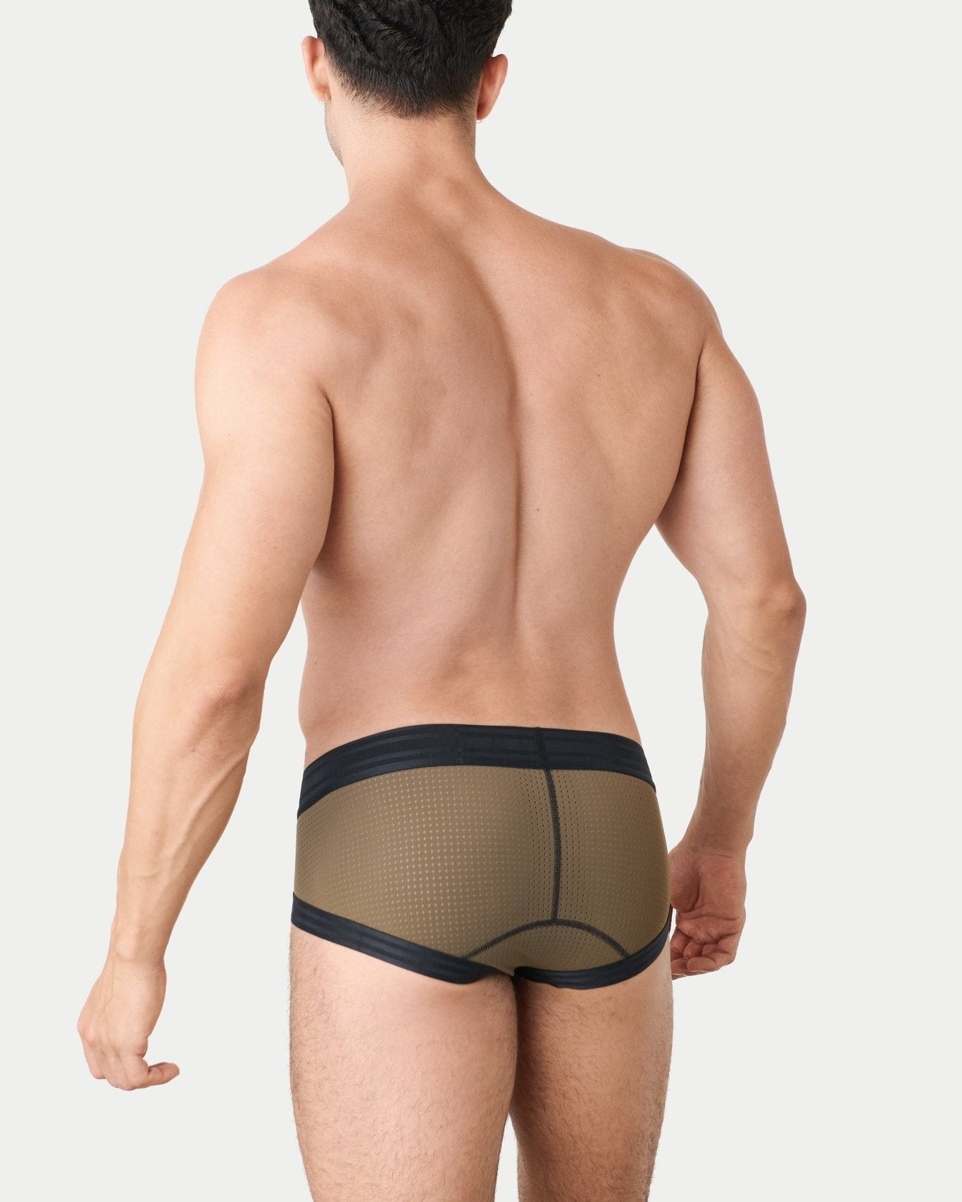 Awry Lift Brief Moss Black - men's enhancing brief back view, lifestyle shot