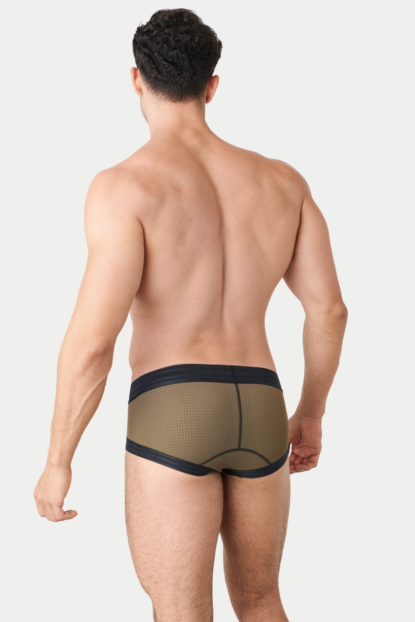 Awry Lift Brief Moss Black - men's enhancing brief back view, lifestyle shot