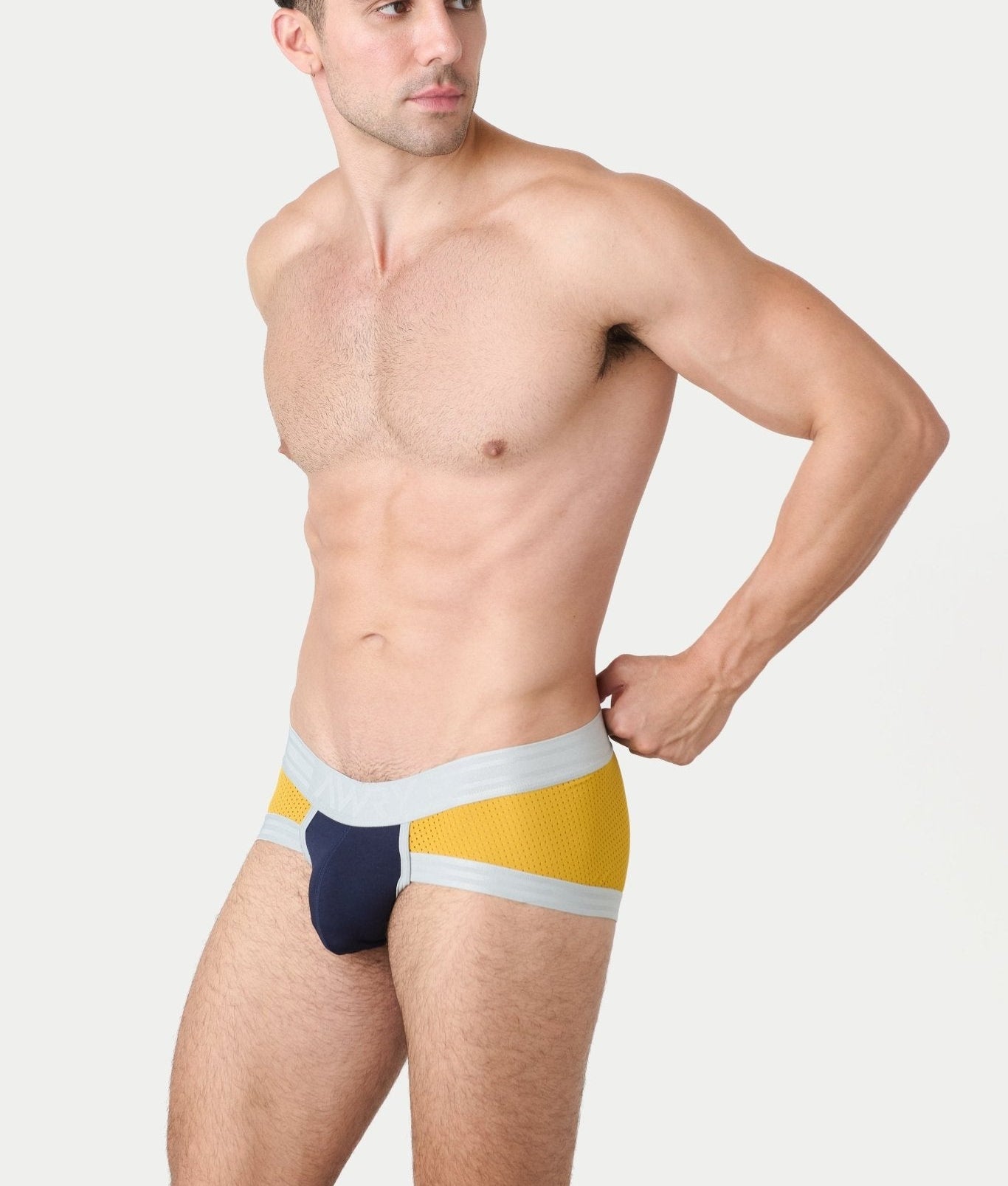 Awry Lift Brief Navy Gold — detail shot of branded waistband and 4-way stretch mesh fabric