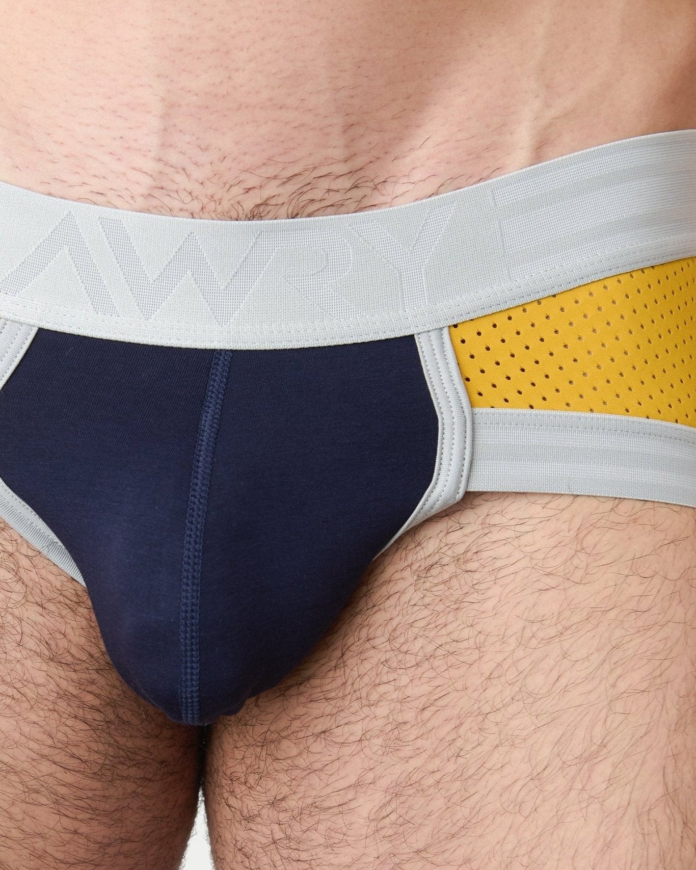 Awry Lift Brief Navy Gold — rear view showing built-in jockstrap strap system and lift construction