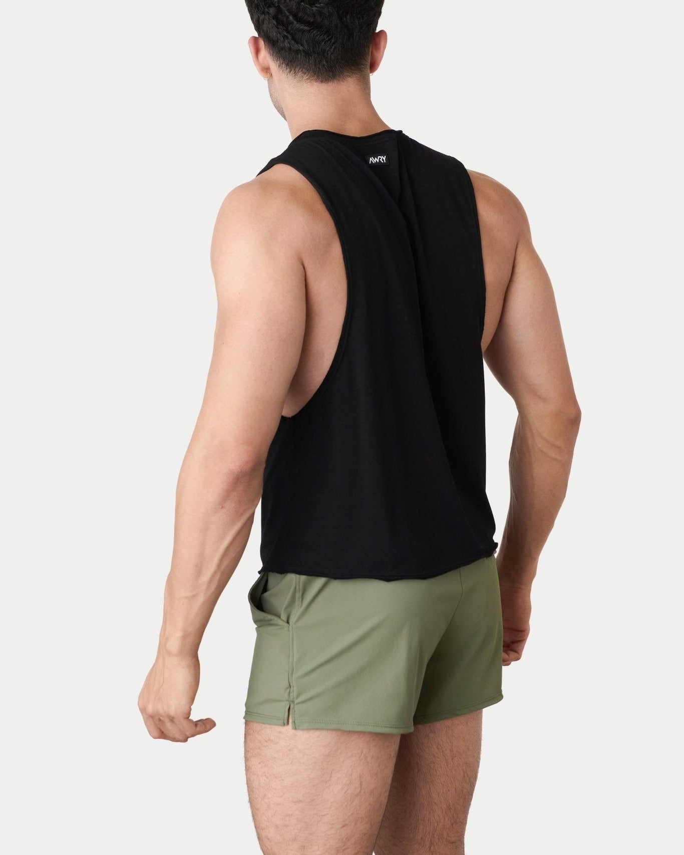 Awry Raw Crop Tank Black — side view showing cropped midriff-exposing silhouette