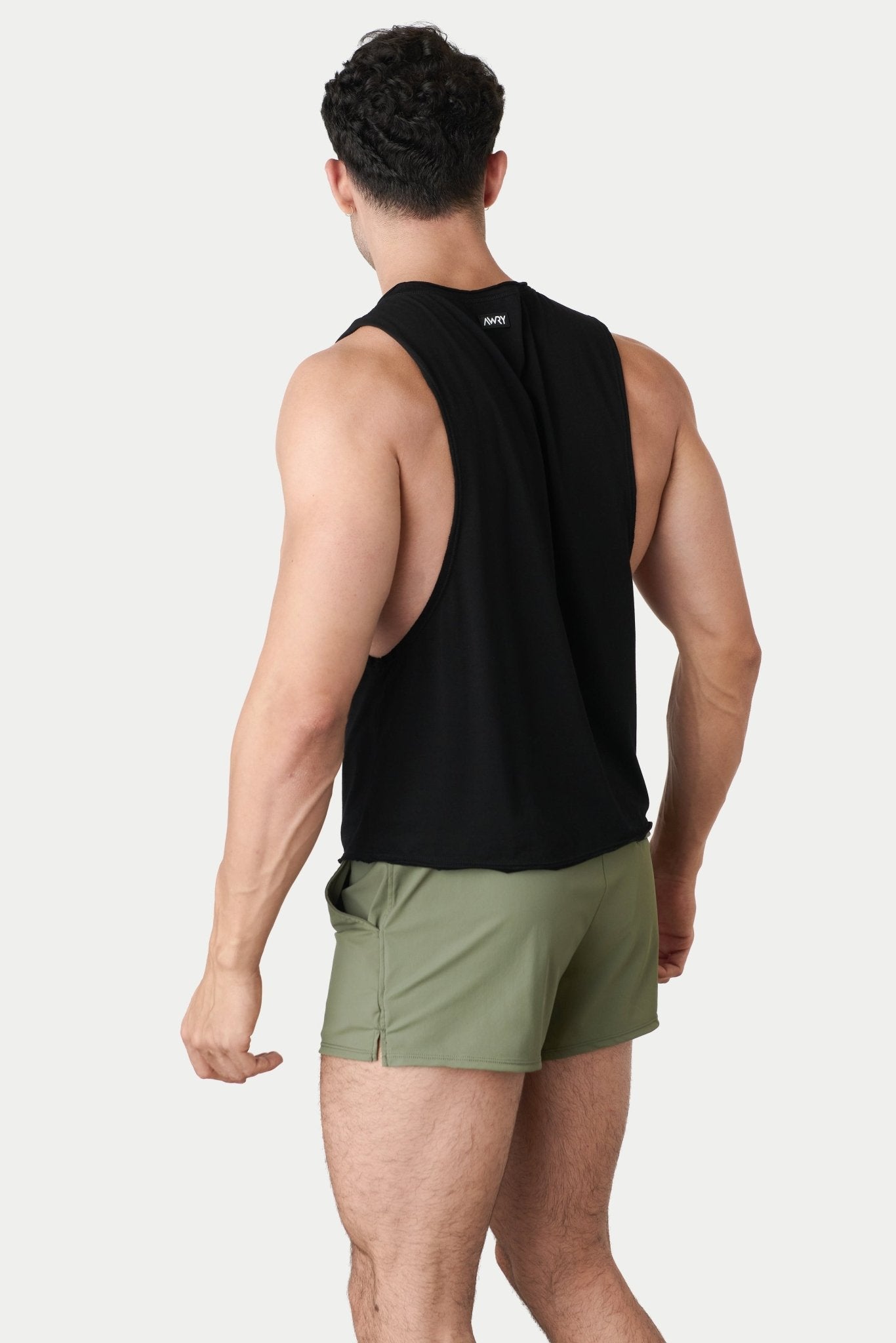 Awry Raw Crop Tank Black — side view showing cropped midriff-exposing silhouette