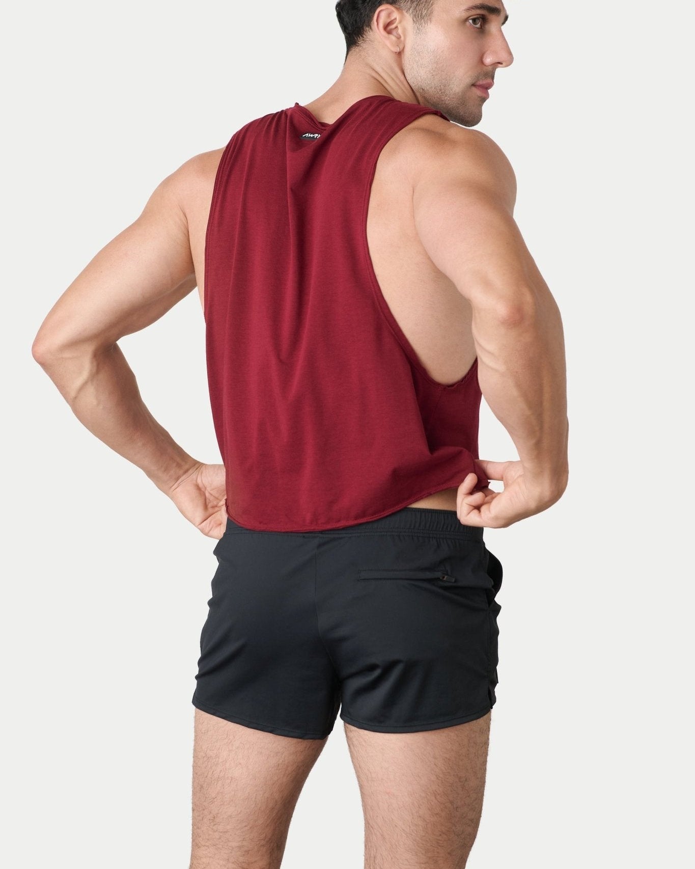 Awry Raw Crop Tank Maroon — close-up of raw unfinished edge at collar and armhole