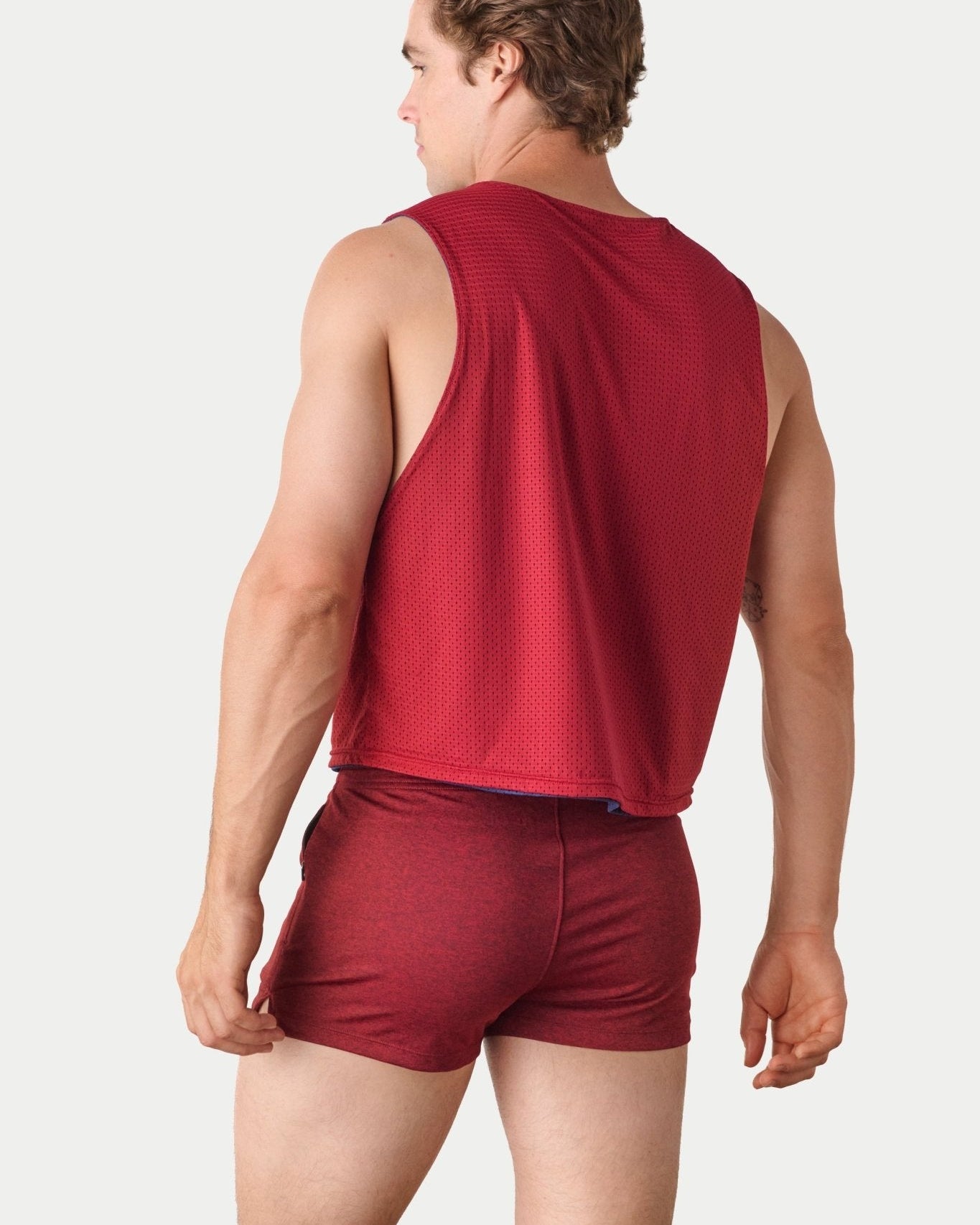Awry Rookie Reversible Tank Navy & Red — side view showing semi-cropped silhouette and mesh construction