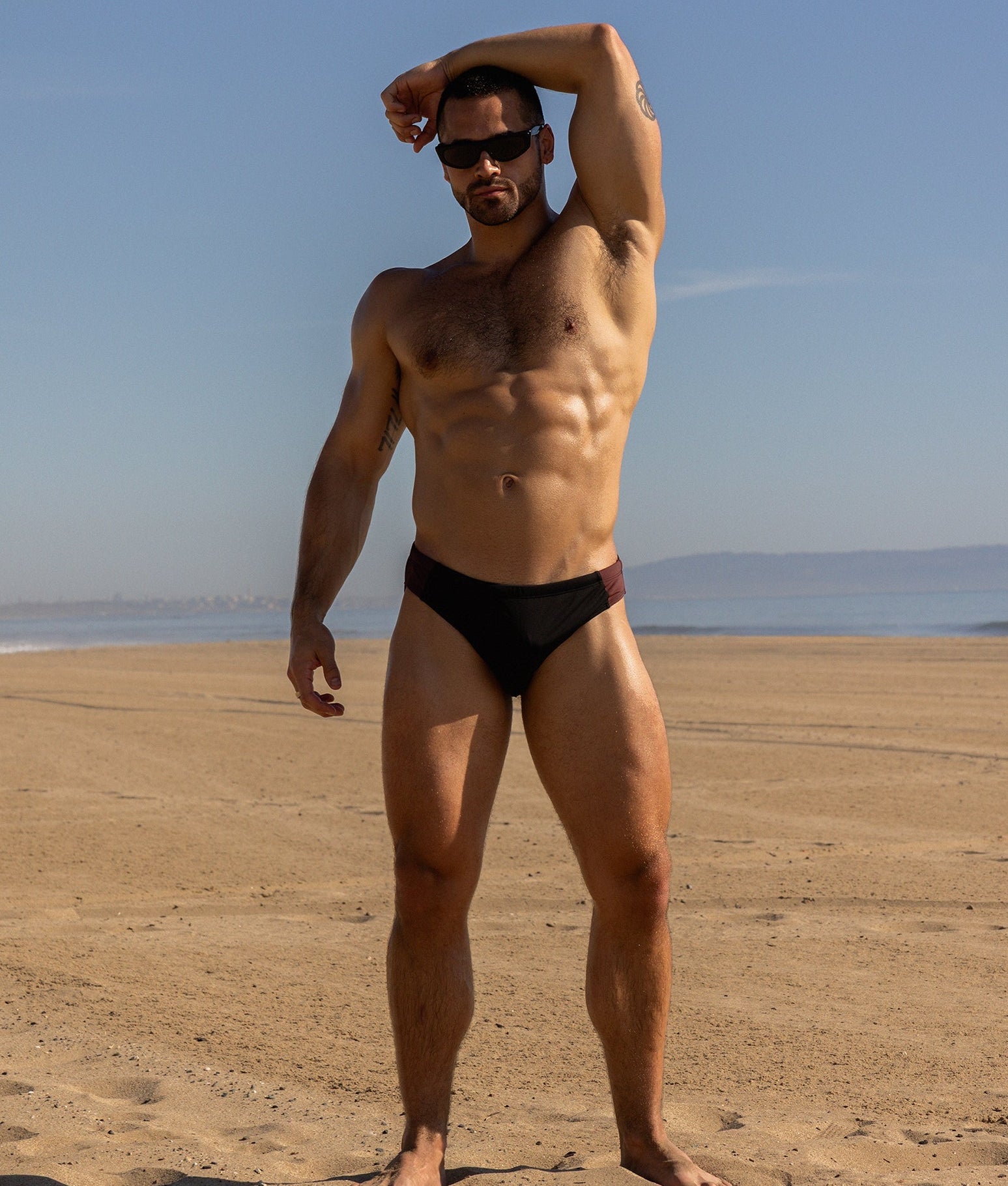 Sean & Val Sports Brief Black/Palermo — men's swim brief lifestyle shot at beach or pool
