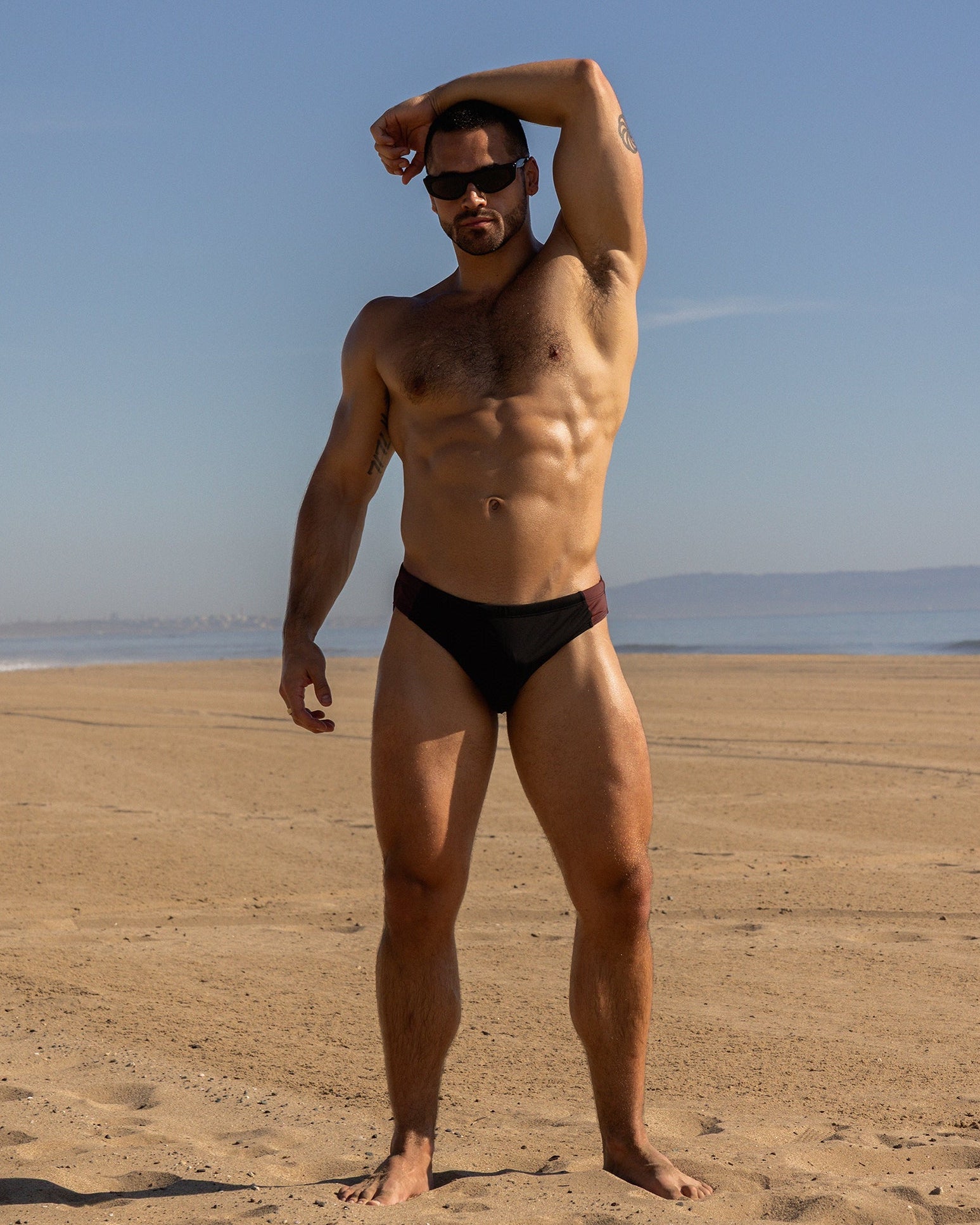Sean & Val Sports Brief Black/Palermo — men's swim brief lifestyle shot at beach or pool