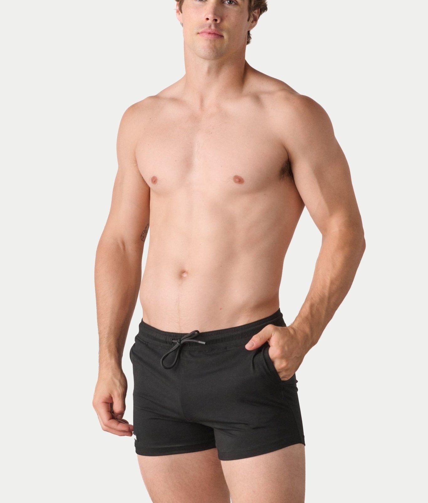 Awry Vers Short V2.1 Black — detail of logo patch and molded aglets on improved drawstring