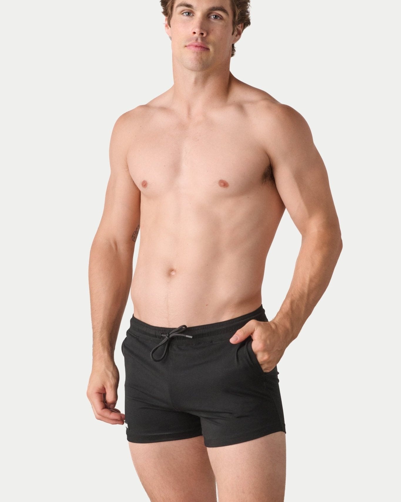 Awry Vers Short V2.1 Black — detail of logo patch and molded aglets on improved drawstring