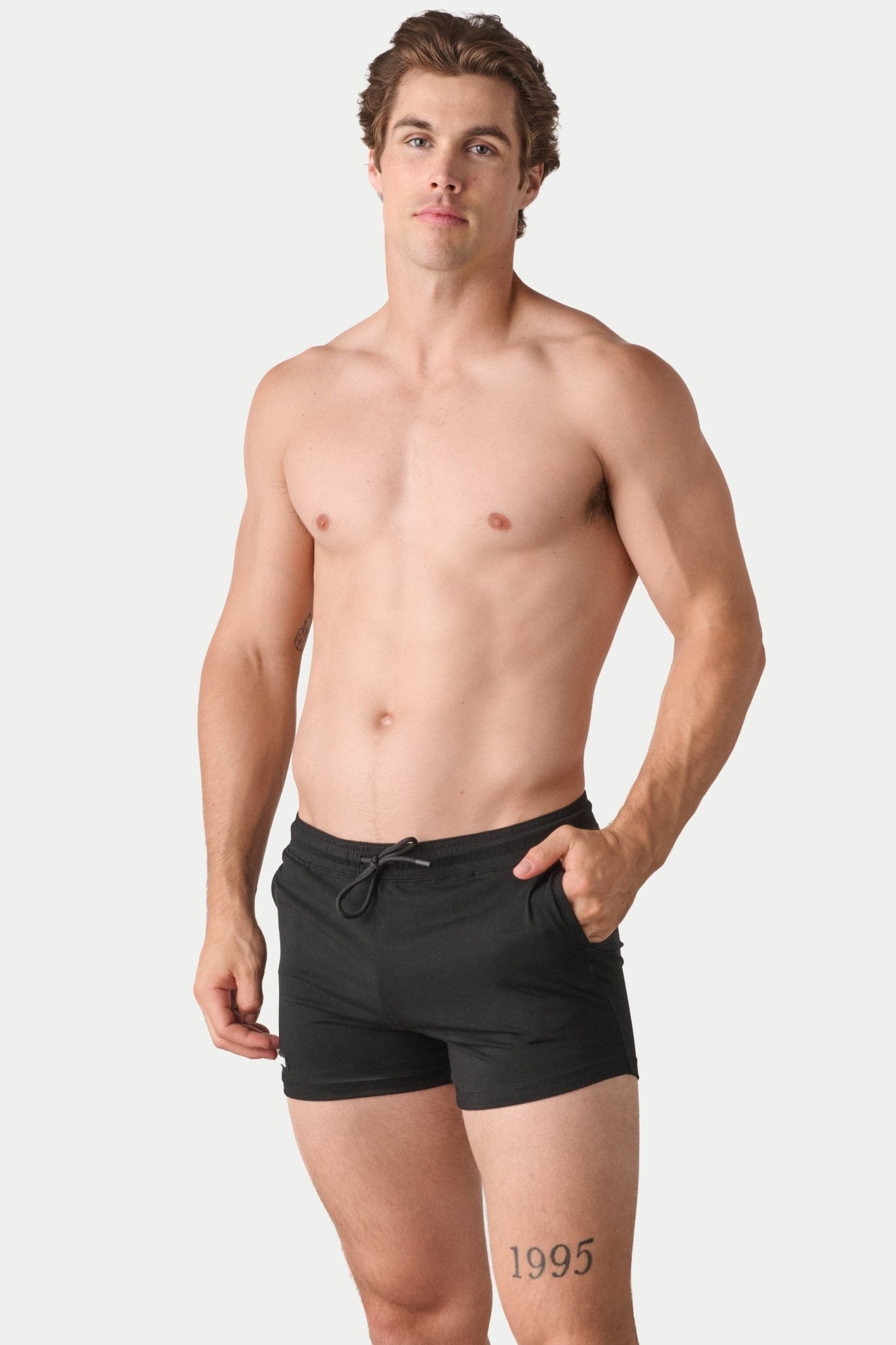Awry Vers Short V2.1 Black — detail of logo patch and molded aglets on improved drawstring