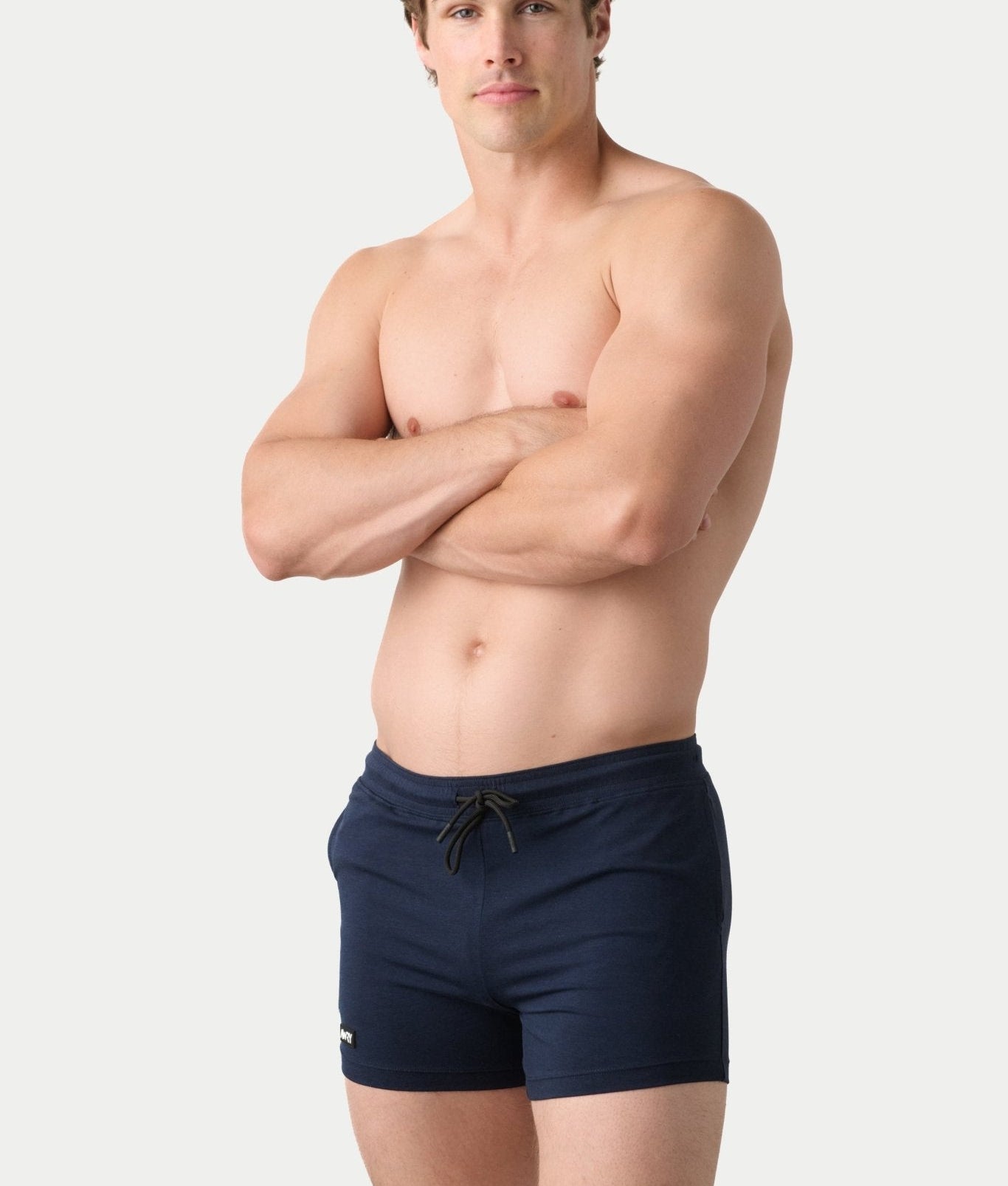 Awry Vers Short V2.1 Navy — detail of logo patch and molded aglets on improved drawstring