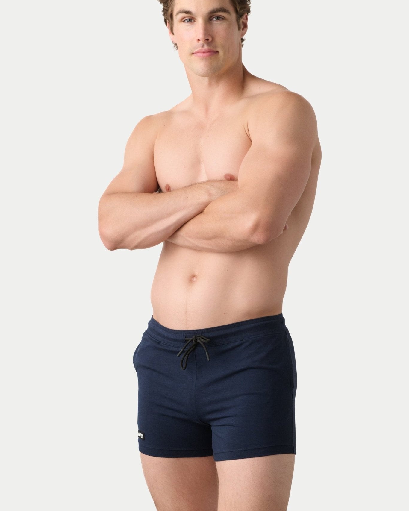 Awry Vers Short V2.1 Navy — detail of logo patch and molded aglets on improved drawstring