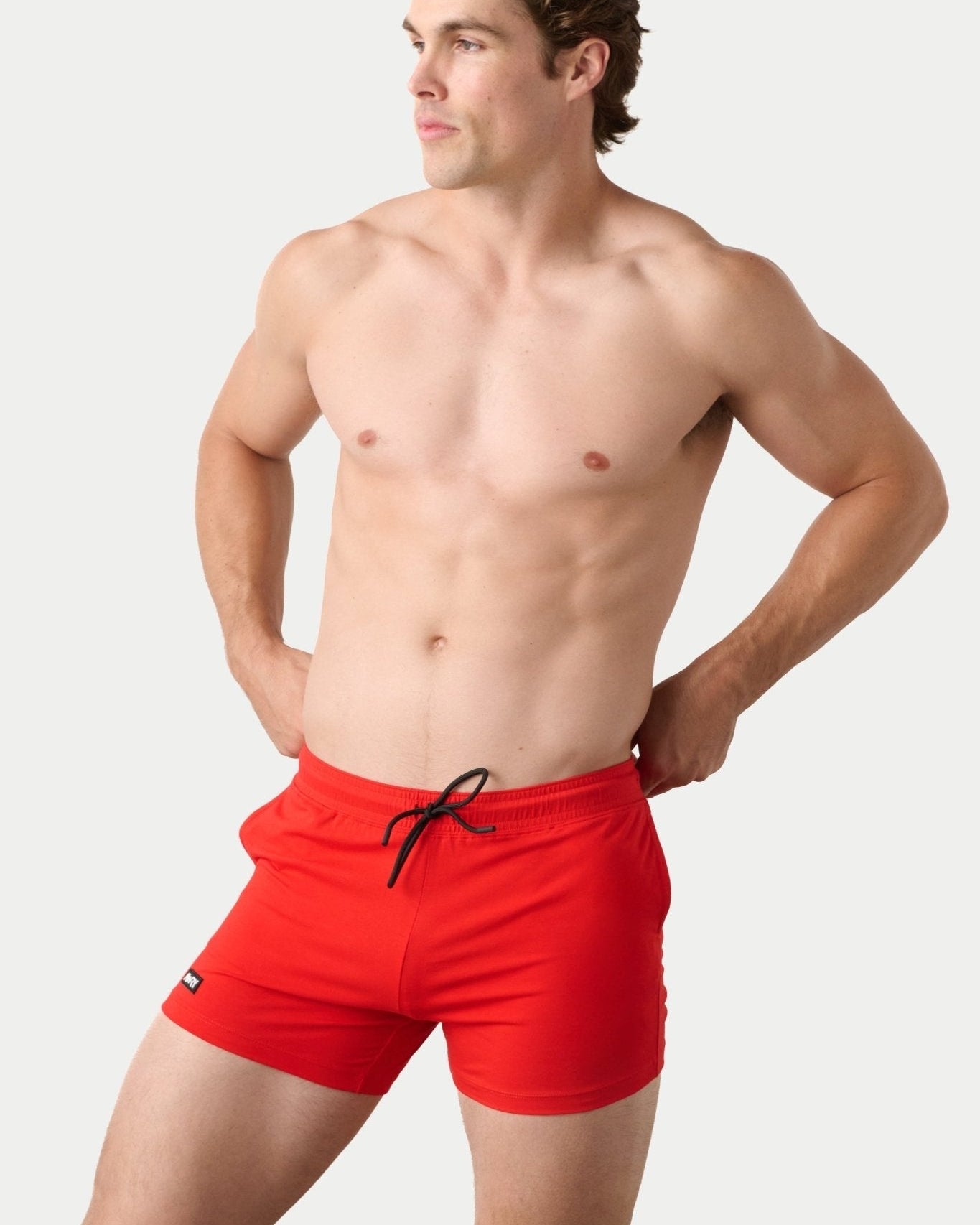 Awry Vers Short V2.1 Red — detail of logo patch and molded aglets on improved drawstring