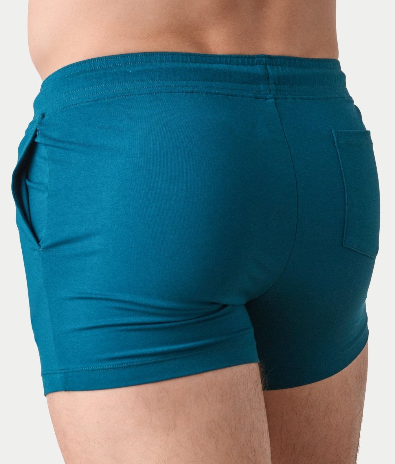 Awry Vers Short V2.1 Teal — side view showing roomy front pocket and drawstring waistband
