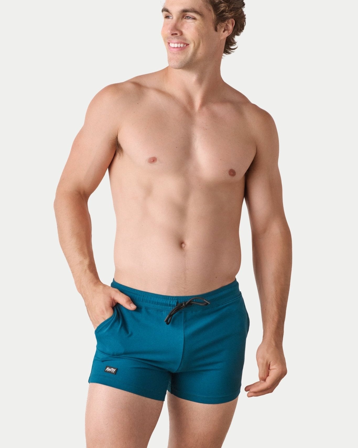 Awry Vers Short V2.1 Teal — detail of logo patch and molded aglets on improved drawstring