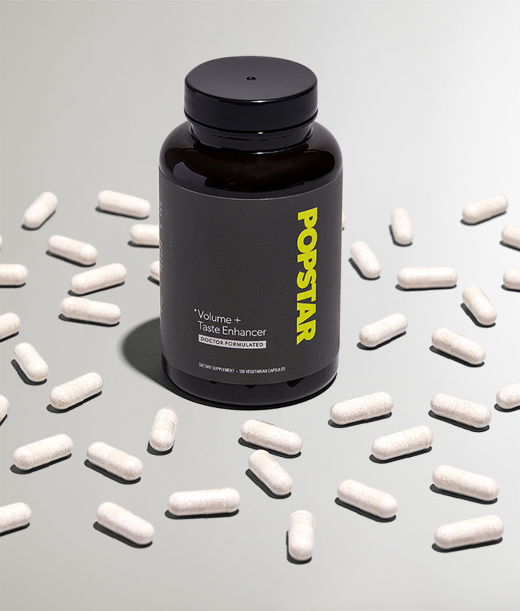 Popstar Volume + Taste Enhancer black bottle surrounded by white vegan capsules – doctor-formulated men's supplement, 120 count