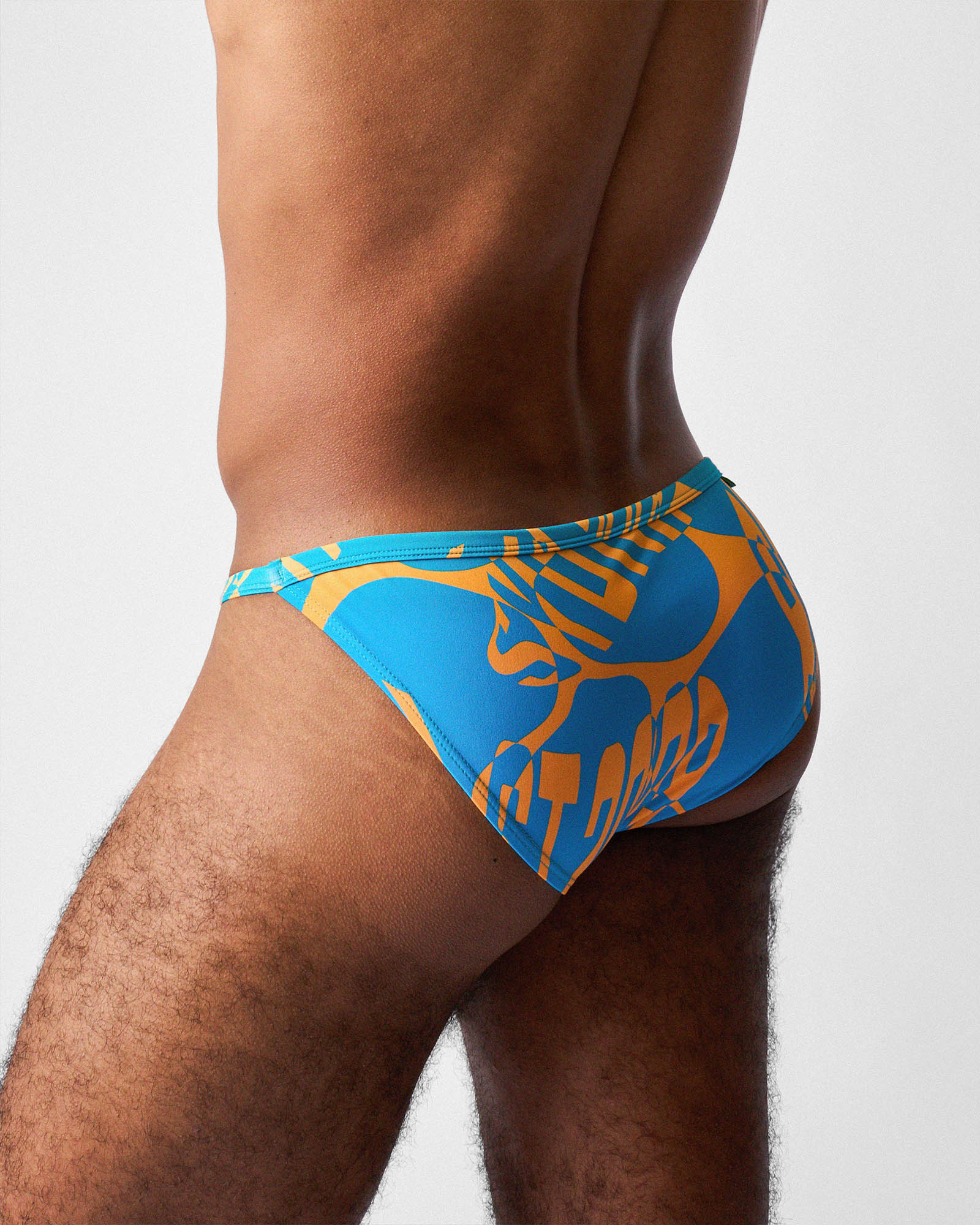 Teamm8 Harbour City Micro Swim Brief Tropical - men's cut-out side swim brief poolside, side view
