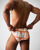 Teamm8 Headliner Bikini Swim Brief Orange - men's bikini swim brief poolside, side view