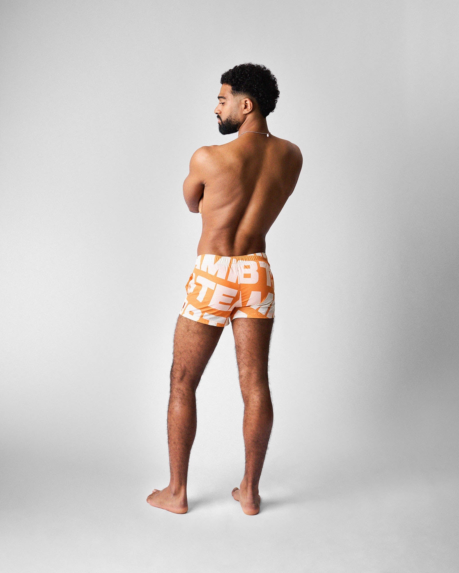 Teamm8 Headliner Swim Short Orange - men's statement swim short, lifestyle beach shot
