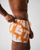 Teamm8 Headliner Swim Short Orange - deconstructed logo print detail, close-up
