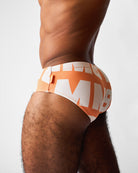 Teamm8 Headliner Wide Swim Brief Orange - men's quick-dry swim brief poolside, side view