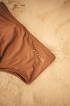 Étalon Brown Swim Sunga - men's swim brief action shot by water