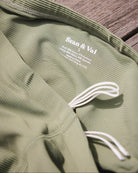 Sean & Val Ribbed Racer Brief Sage — men's swim brief lifestyle shot at beach or pool