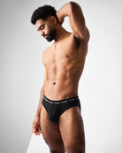 Teamm8 Ultra Swim Brief Jet - men's black swim brief at pool, lifestyle view