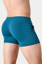Awry Flow 4 Inch Short V2 Teal — side view showing roomy front pocket and smooth waistband
