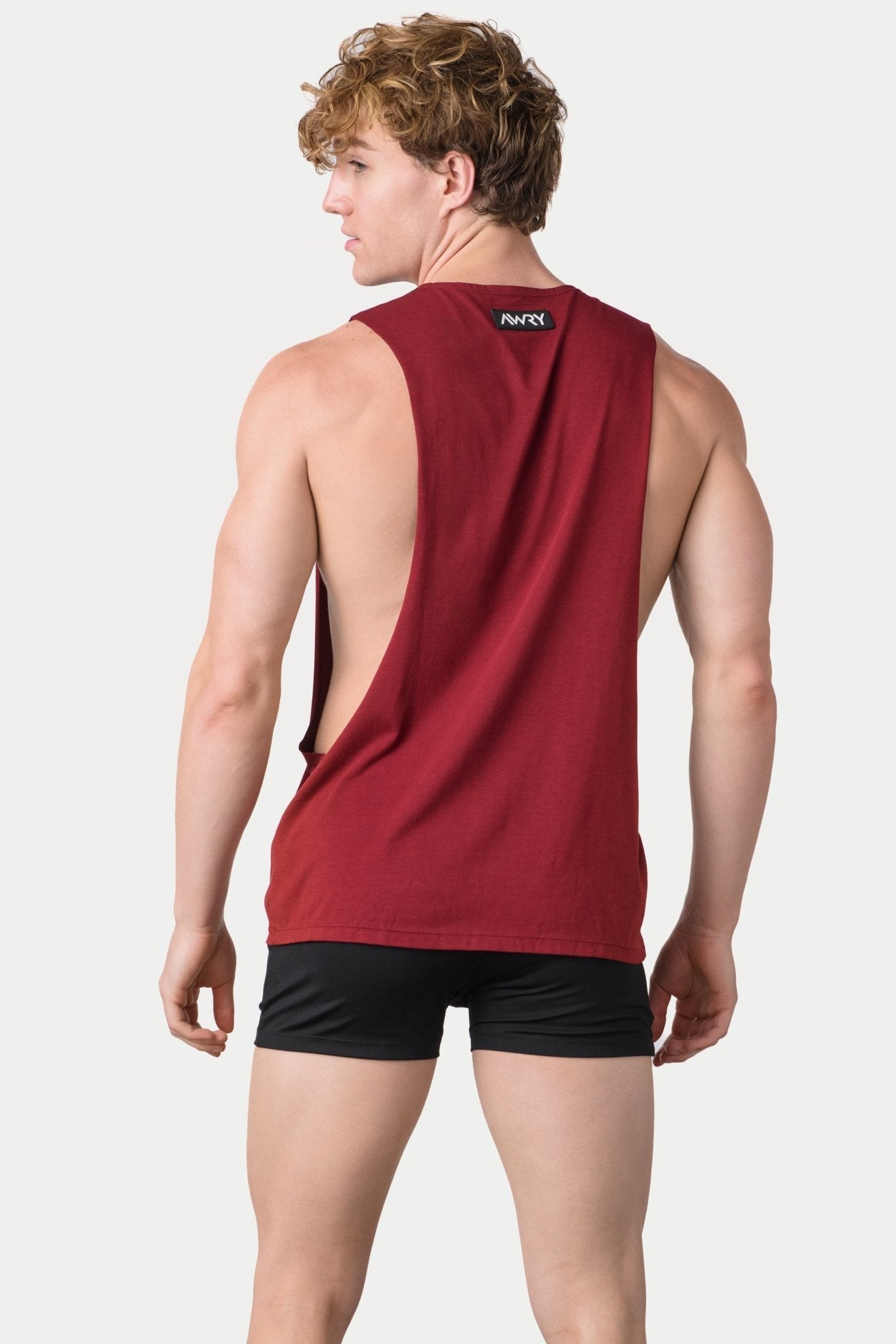 Awry Impact Tank Maroon — side view showing deep armhole cutout and relaxed draped silhouette
