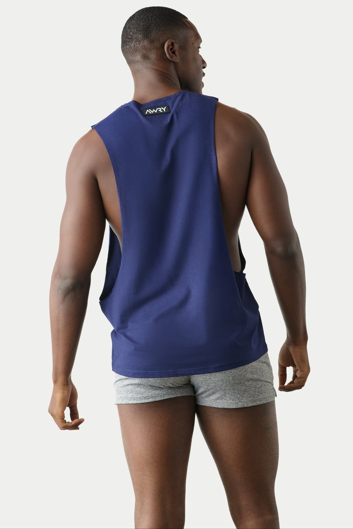 Awry Impact Tank Navy — side view showing deep armhole cutout and relaxed draped silhouette