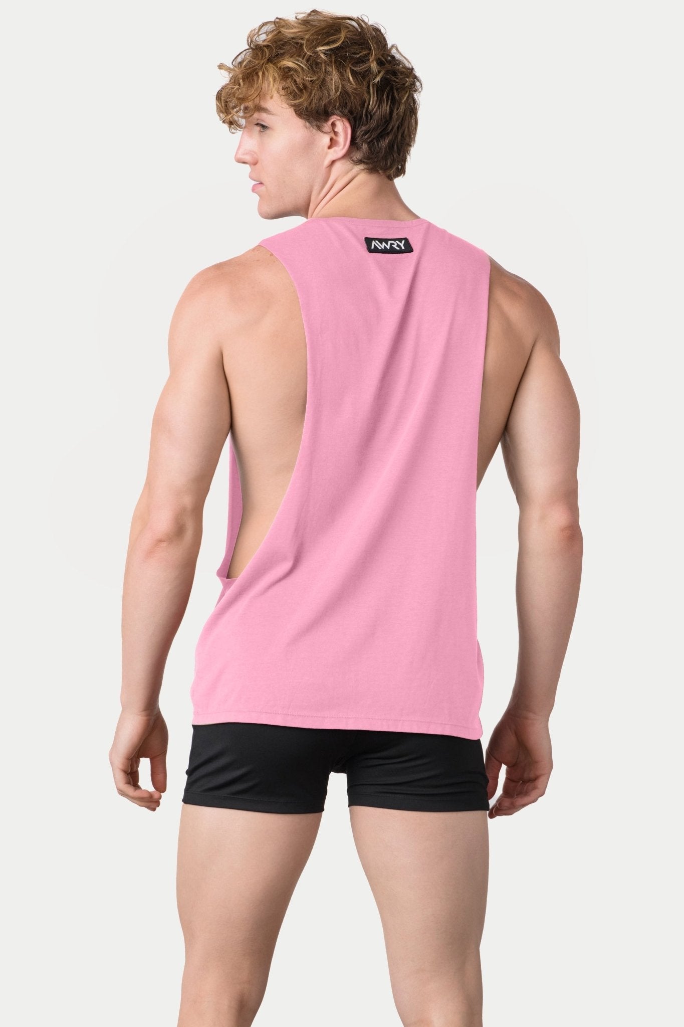 Awry Impact Tank Pink — side view showing deep armhole cutout and relaxed draped silhouette