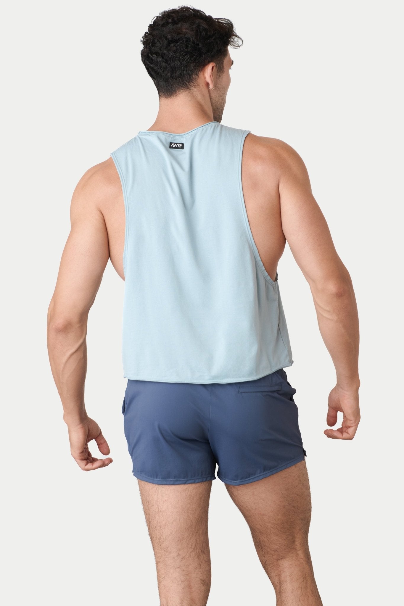 Awry Raw Crop Tank Soft Blue — close-up of raw unfinished edge at collar and armhole