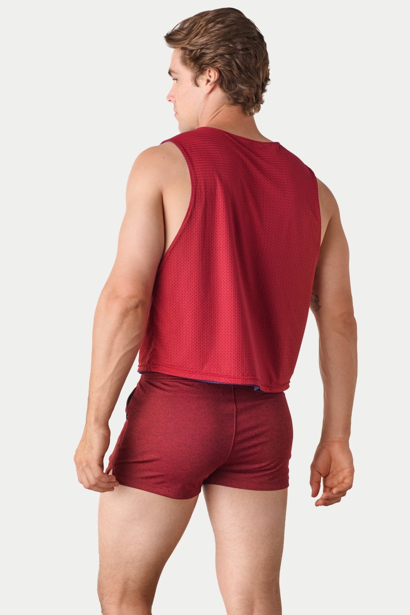 Awry Rookie Reversible Tank Navy & Red — side view showing semi-cropped silhouette and mesh construction
