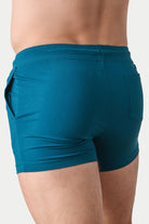 Awry Vers Short V2.1 Teal — side view showing roomy front pocket and drawstring waistband