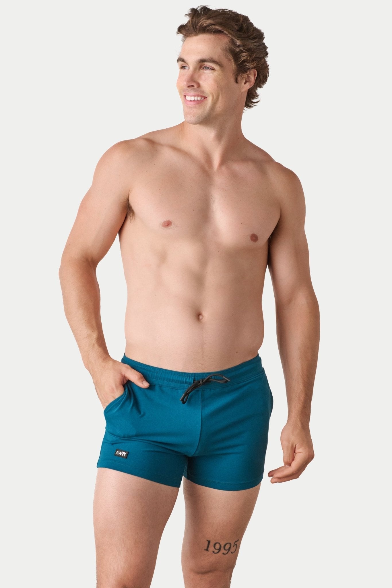 Awry Vers Short V2.1 Teal — detail of logo patch and molded aglets on improved drawstring